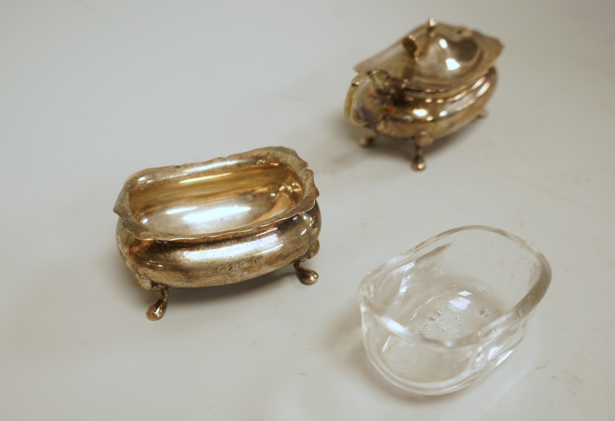 A pair of small George V silver five bar toast racks, Adie Brothers, Birmingham, 1930, length 76mm, together with six assorted silver condiments.